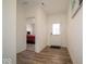 Inviting hallway with wood floors, white walls, and view into bedroom at 7234 Darley Ln, Indianapolis, IN 46259
