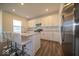 Modern kitchen with white cabinetry, stainless steel appliances, granite countertops and an island with seating at 7234 Darley Ln, Indianapolis, IN 46259