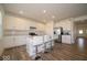 Bright, modern kitchen featuring white cabinets, stainless steel appliances, and a large island with bar seating at 7234 Darley Ln, Indianapolis, IN 46259
