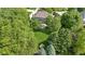 Aerial view of home nestled among mature trees showcasing the expansive green lawn at 7372 Fox Hollow Rdg, Zionsville, IN 46077