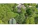 Aerial view of a home surrounded by mature trees and lush greenery offering privacy at 7372 Fox Hollow Rdg, Zionsville, IN 46077