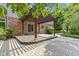 An outdoor stone patio featuring a wooden pergola perfect for entertaining or relaxing at 7372 Fox Hollow Rdg, Zionsville, IN 46077