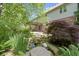 Beautiful backyard featuring mature trees, patio area, water feature and lush garden at 7372 Fox Hollow Rdg, Zionsville, IN 46077
