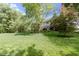 Sprawling backyard with a lush lawn and mature trees at 7372 Fox Hollow Rdg, Zionsville, IN 46077