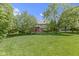 Expansive backyard with mature trees and green grass area at 7372 Fox Hollow Rdg, Zionsville, IN 46077