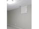 Finished basement showing neutral carpeting and walls along with a recessed utility access panel at 7372 Fox Hollow Rdg, Zionsville, IN 46077
