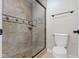 Bathroom featuring a tiled shower with glass door and a comfort height toilet at 7372 Fox Hollow Rdg, Zionsville, IN 46077