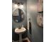 A pedestal sink in a powder room featuring decorative walls and lighting at 7372 Fox Hollow Rdg, Zionsville, IN 46077