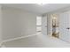 Bedroom with neutral walls, carpet, and open door to ensuite bathroom at 7372 Fox Hollow Rdg, Zionsville, IN 46077