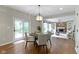 Cozy dining area with a view to a well-lit living room and access to the outdoor patio at 7372 Fox Hollow Rdg, Zionsville, IN 46077