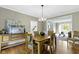 Elegant dining room with hardwood floors and a modern chandelier over the dining table at 7372 Fox Hollow Rdg, Zionsville, IN 46077