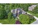 Aerial view of a well-maintained brick home featuring mature landscaping and a private setting at 7372 Fox Hollow Rdg, Zionsville, IN 46077