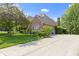 Well-maintained exterior with beautiful landscaping and a long driveway at 7372 Fox Hollow Rdg, Zionsville, IN 46077