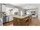 Well-appointed kitchen with granite countertops, a breakfast bar, and a view into the Gathering room at 7372 Fox Hollow Rdg, Zionsville, IN 46077