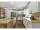Functional kitchen with white cabinets, granite counters, and stainless steel appliances at 7372 Fox Hollow Rdg, Zionsville, IN 46077