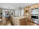 Open-concept kitchen with a large island, stainless steel appliances, and custom cabinetry at 7372 Fox Hollow Rdg, Zionsville, IN 46077