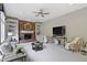 Bright living room with a brick fireplace, built-in shelving, and neutral decor at 7372 Fox Hollow Rdg, Zionsville, IN 46077