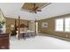 Spacious main bedroom features a tray ceiling, four-poster bed, and large windows at 7372 Fox Hollow Rdg, Zionsville, IN 46077