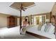 Comfortable main bedroom features a four-poster bed, walk-in closet, and ensuite bathroom at 7372 Fox Hollow Rdg, Zionsville, IN 46077
