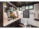 Modern farmhouse bathroom offers double sinks, statement lighting and decor at 7730 Bear Creek Rd, Morgantown, IN 46160