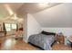 An upper bedroom with an A-frame roof and dormers, featuring a cozy sitting area and ample natural light at 7730 Bear Creek Rd, Morgantown, IN 46160