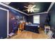 Fun bedroom with a galaxy mural, ceiling fan, and a cozy space at 7730 Bear Creek Rd, Morgantown, IN 46160