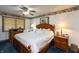 Cozy bedroom features classic wood furniture, ceiling fan and soft lighting at 7730 Bear Creek Rd, Morgantown, IN 46160
