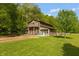 Charming, rustic home with a bright blue front door, surrounded by a sprawling lawn and mature trees at 7730 Bear Creek Rd, Morgantown, IN 46160