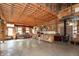 Expansive kitchen and living area with custom wood accents, ample countertop space, and a cozy wood stove at 7730 Bear Creek Rd, Morgantown, IN 46160