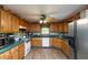 Functional kitchen with wooden cabinets, modern appliances, and a view to backyard at 7730 Bear Creek Rd, Morgantown, IN 46160