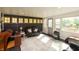 Living room with dark accent wall, multiple windows, and a sliding door to the outdoors at 7730 Bear Creek Rd, Morgantown, IN 46160