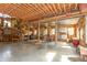 Large living room with exposed beams, wood accents, a cozy seating area and multiple windows providing natural light at 7730 Bear Creek Rd, Morgantown, IN 46160