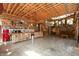 Spacious living area with kitchen and cozy seating area with wood accents and string lights at 7730 Bear Creek Rd, Morgantown, IN 46160