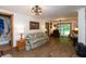 Comfortable living room with wood floors, a cozy sofa, and bright natural light at 7730 Bear Creek Rd, Morgantown, IN 46160