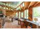 Open-concept living room with a foosball table, vaulted ceilings, and abundant natural light at 7730 Bear Creek Rd, Morgantown, IN 46160