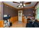 Study with dark wood paneling, an office table, and a small black leather sofa at 7730 Bear Creek Rd, Morgantown, IN 46160