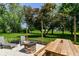 Backyard with patio, outdoor furniture, fire pit and plenty of greenery at 7771 Delbrook Dr, Indianapolis, IN 46260