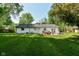 Expansive backyard featuring a patio with outdoor seating and a well-maintained lawn, creating a private oasis at 7771 Delbrook Dr, Indianapolis, IN 46260