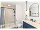Nicely decorated bathroom featuring shiplap walls, tiled shower, and modern fixtures at 7771 Delbrook Dr, Indianapolis, IN 46260