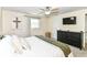 Bright bedroom featuring neutral carpet, a ceiling fan, a television, and neutral walls at 7771 Delbrook Dr, Indianapolis, IN 46260