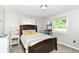 Bedroom with natural light, carpet, and a full sized bed with a wooden frame at 7771 Delbrook Dr, Indianapolis, IN 46260