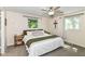 Cozy bedroom featuring neutral carpet, a ceiling fan, and windows offering natural light at 7771 Delbrook Dr, Indianapolis, IN 46260