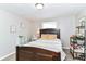 Bedroom with natural light, carpet, and a full sized bed with a wooden frame at 7771 Delbrook Dr, Indianapolis, IN 46260