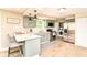 Updated kitchen featuring sage green cabinets, subway tile backsplash, stainless appliances, and a breakfast bar at 7771 Delbrook Dr, Indianapolis, IN 46260