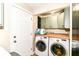 Convenient laundry room features cabinetry, countertop, and a washer and dryer, plus exterior access at 7771 Delbrook Dr, Indianapolis, IN 46260