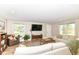 Spacious living room featuring hardwood floors, a comfortable sectional sofa, and natural light at 7771 Delbrook Dr, Indianapolis, IN 46260