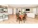 Open concept living space featuring hardwood flooring, dining area, living room, and kitchen with breakfast bar at 7771 Delbrook Dr, Indianapolis, IN 46260
