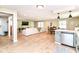Open concept living space featuring hardwood flooring, dining area, living room, and kitchen with breakfast bar at 7771 Delbrook Dr, Indianapolis, IN 46260