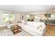 Inviting living room with an open concept layout, seamlessly connecting to the dining and kitchen areas at 7771 Delbrook Dr, Indianapolis, IN 46260