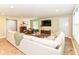 Comfortable living room features a sectional sofa, wood floors, and ample natural light at 7771 Delbrook Dr, Indianapolis, IN 46260
